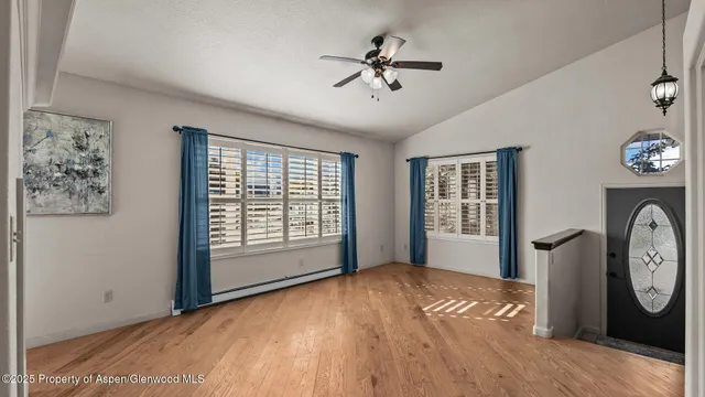 a view of livingroom with window ceiling fan and wooden floor