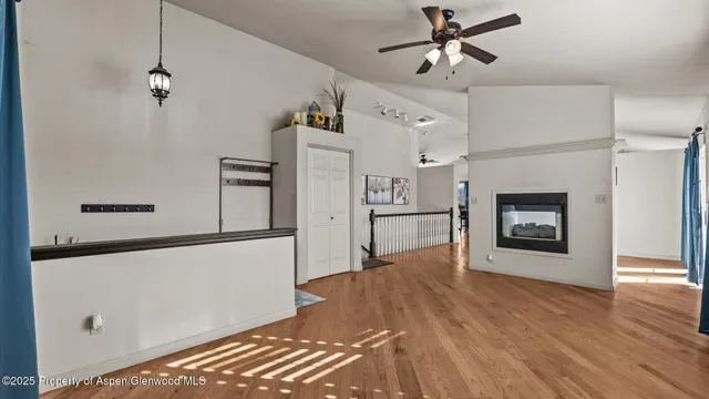 a view of a kitchen with refrigerator and a fireplace