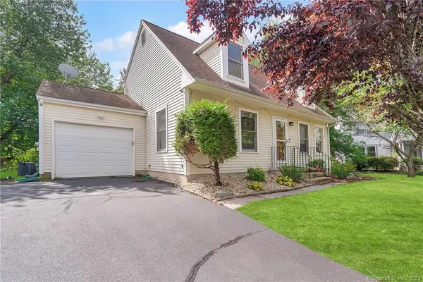 a view of a house with a yard and garage