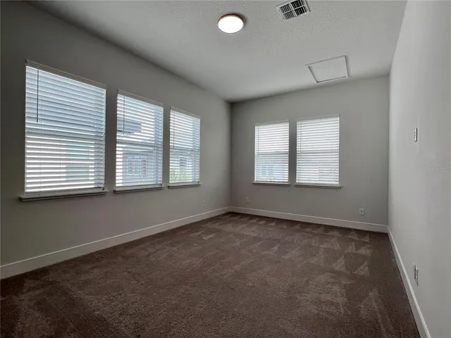 a kitchen with stainless steel appliances granite countertop a refrigerator a sink dishwasher a stove and white countertops with wooden floor