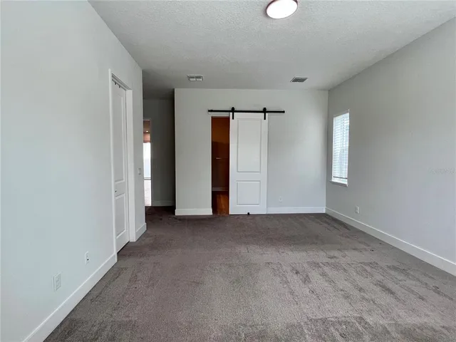 a view of a hallway with wooden floor and a fire place
