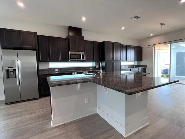 a view of swimming pool with outdoor seating and a garden
