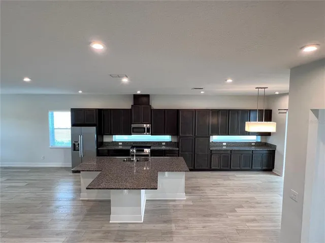 a kitchen with a table and chairs in it