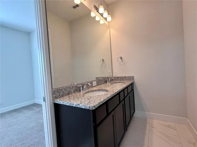 a white bath tub sitting next to a toilet