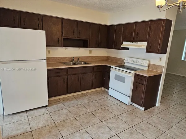 a kitchen with a cabinets and a stove top oven