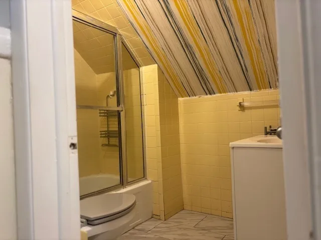 a bathroom with a shower and a sink