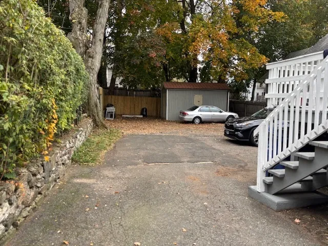 a view of a house with a patio and a yard