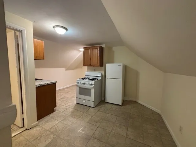 a kitchen with refrigerator stove and sink