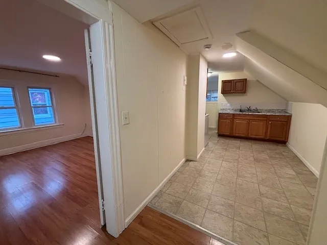 a view of a hallway with wooden floor