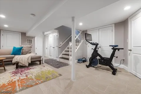 a bedroom with furniture and a rug