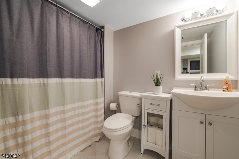 66 Hughes Street Maplewood, NJ 07040 - Photo 16 of 18 a bathroom with a toilet a sink and a mirror