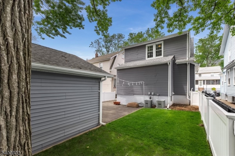66 Hughes Street Maplewood, NJ 07040 - Photo 17 of 18 a view of a backyard with table and chairs and a large tree