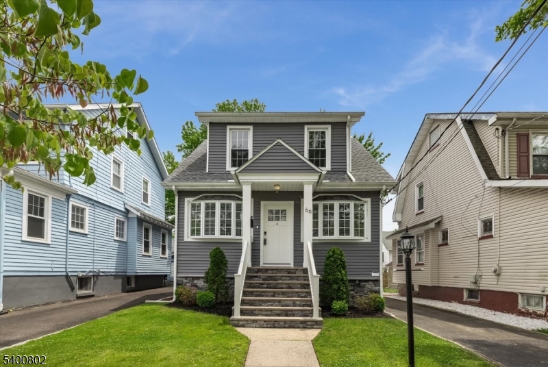 66 Hughes Street Maplewood, NJ 07040 - Photo 2 of 18 a front view of a house with a garden