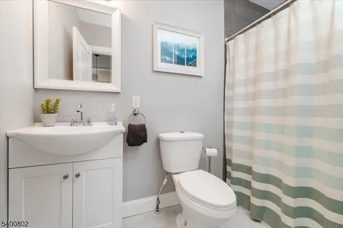a bathroom with a toilet a sink and a mirror