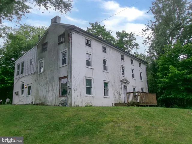 a view of backyard with barbeque oven and trees
