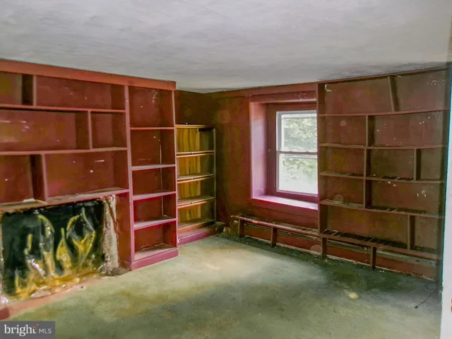 a view of room with wooden floor and windows