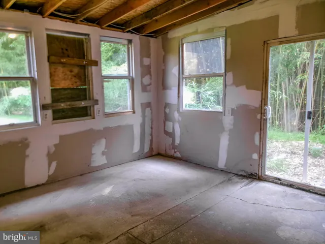 a view of an empty room with large windows