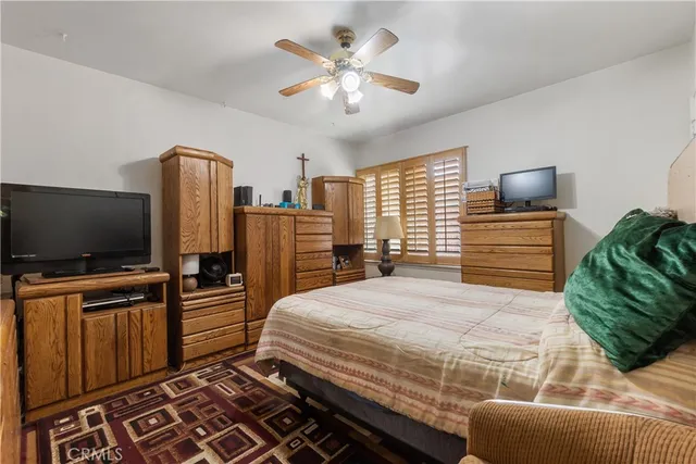 a bedroom with a bed and flat screen tv