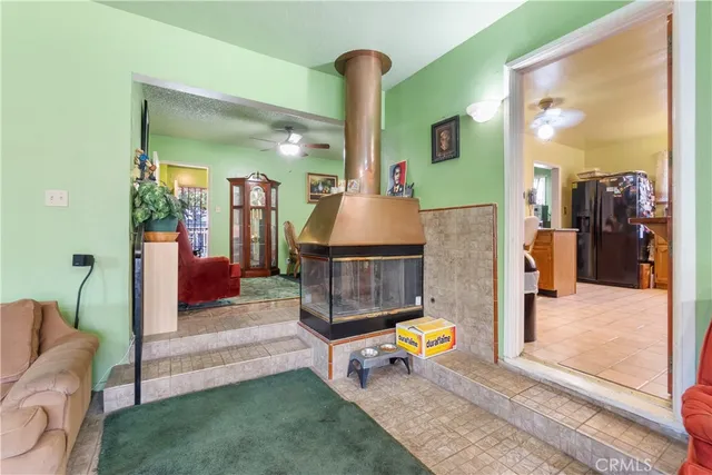 a living room with furniture a rug and a chandelier