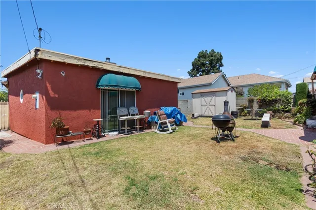 a view of a house with backyard and sitting area