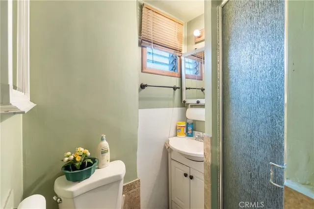 a bathroom with a sink mirror and toilet