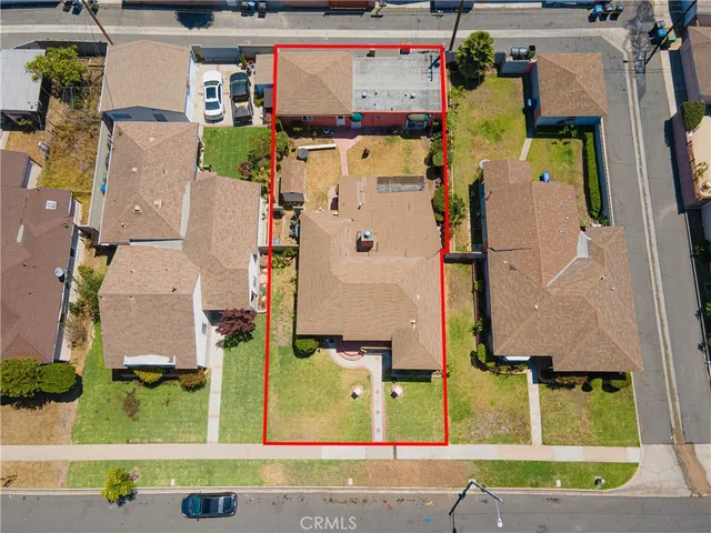 an aerial view of residential house with outdoor space and parking