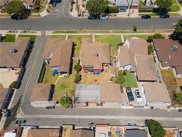 an aerial view of residential houses with outdoor space and swimming pool