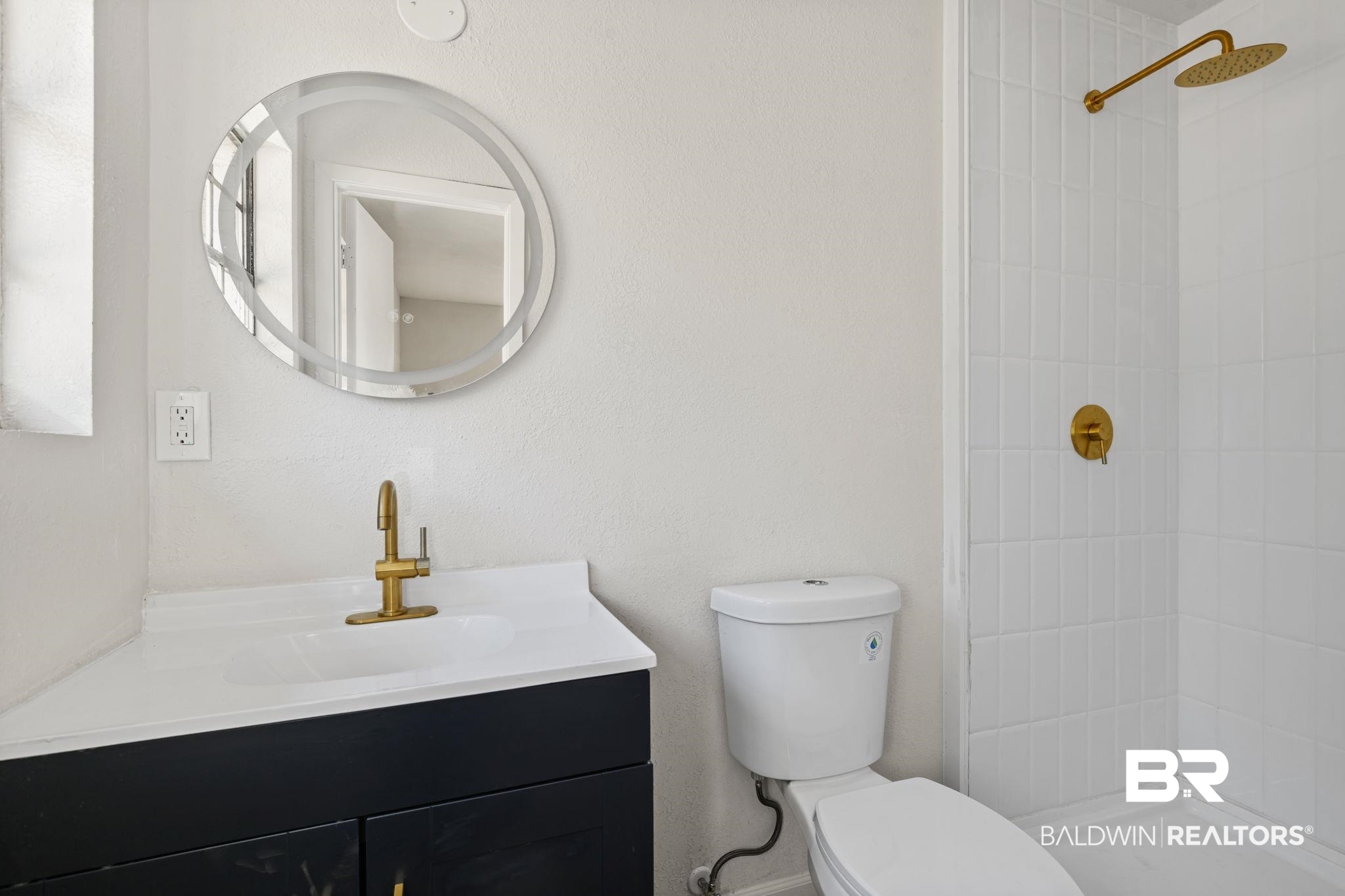 910 Moran Street Bay Minette, AL 36507 - Photo 9 of 20 Bathroom featuring a tile shower, vanity, and a textured wall