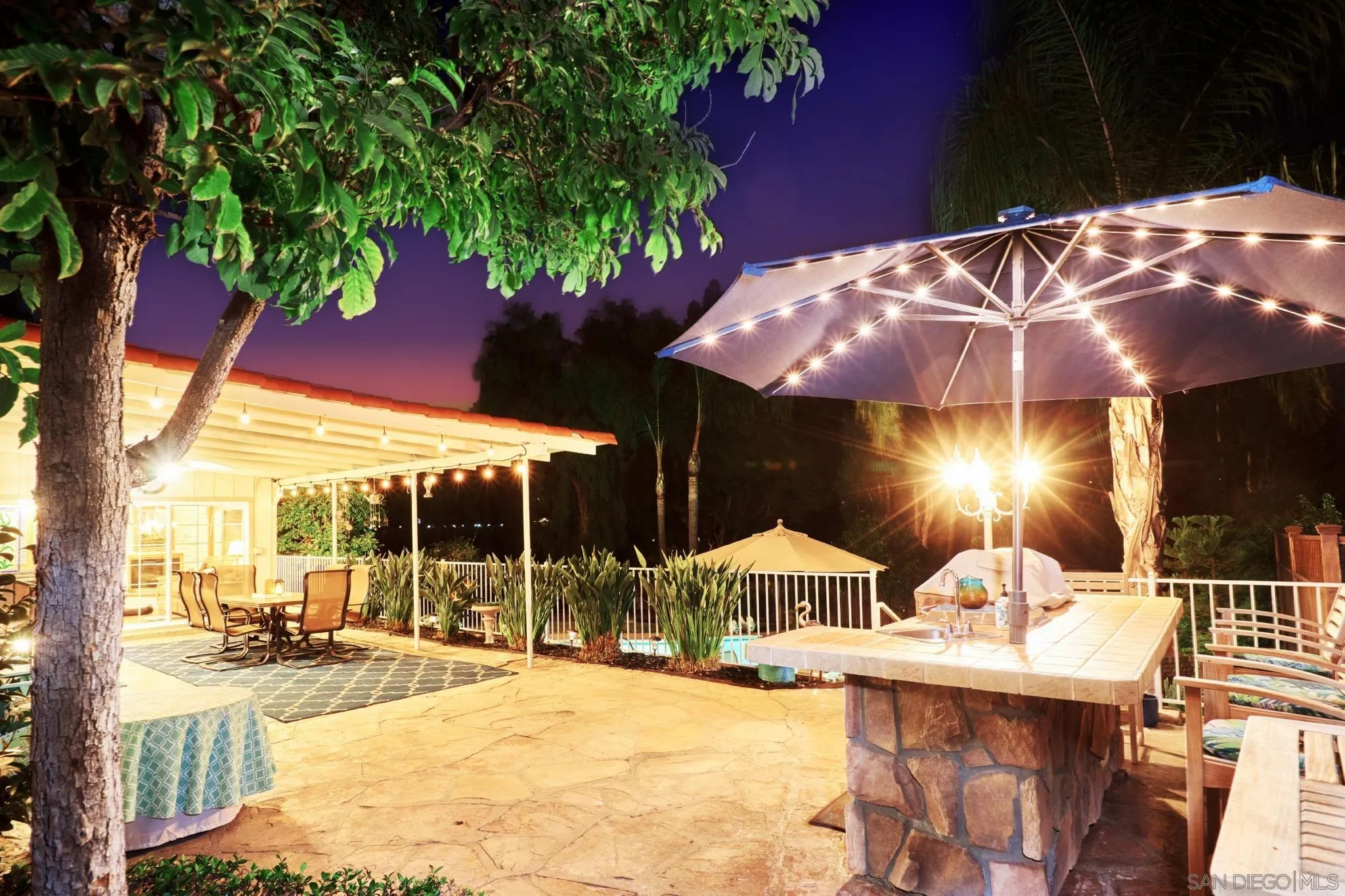 4437 Upland Street La Mesa, CA 91941 - Photo 20 of 24 a view of a patio with a table and chairs under an umbrella