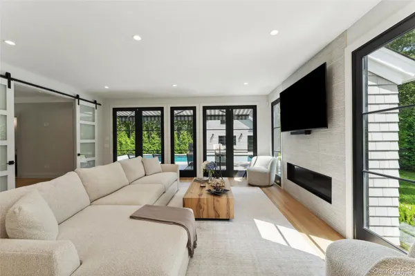 a living room with furniture fireplace and flat screen tv