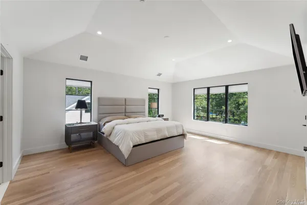 a bedroom with a large bed and a large window