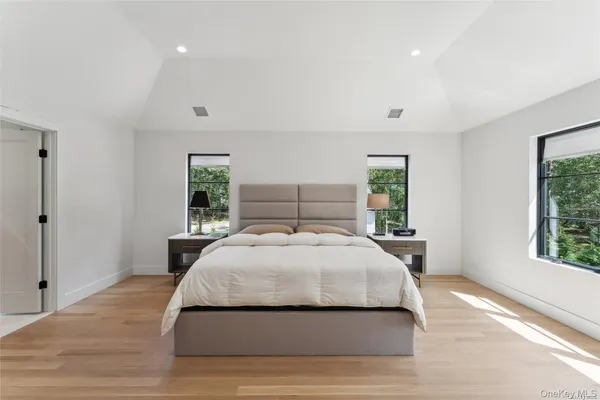 a bedroom with a large bed and a window