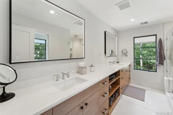 a bathroom with a double vanity sink and a mirror