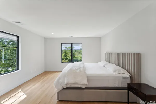 a bed sitting in a bedroom next to a window