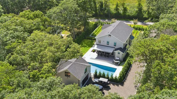 an aerial view of a house with a yard