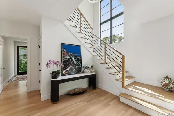 a view of staircase with white walls and wooden floor