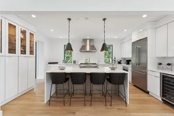a kitchen with a sink and chairs