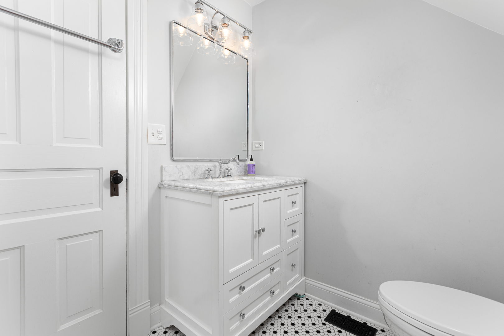 105 South Wright Street Naperville, IL 60540 - Photo 32 of 47 a bathroom with a sink a toilet a shower and a mirror