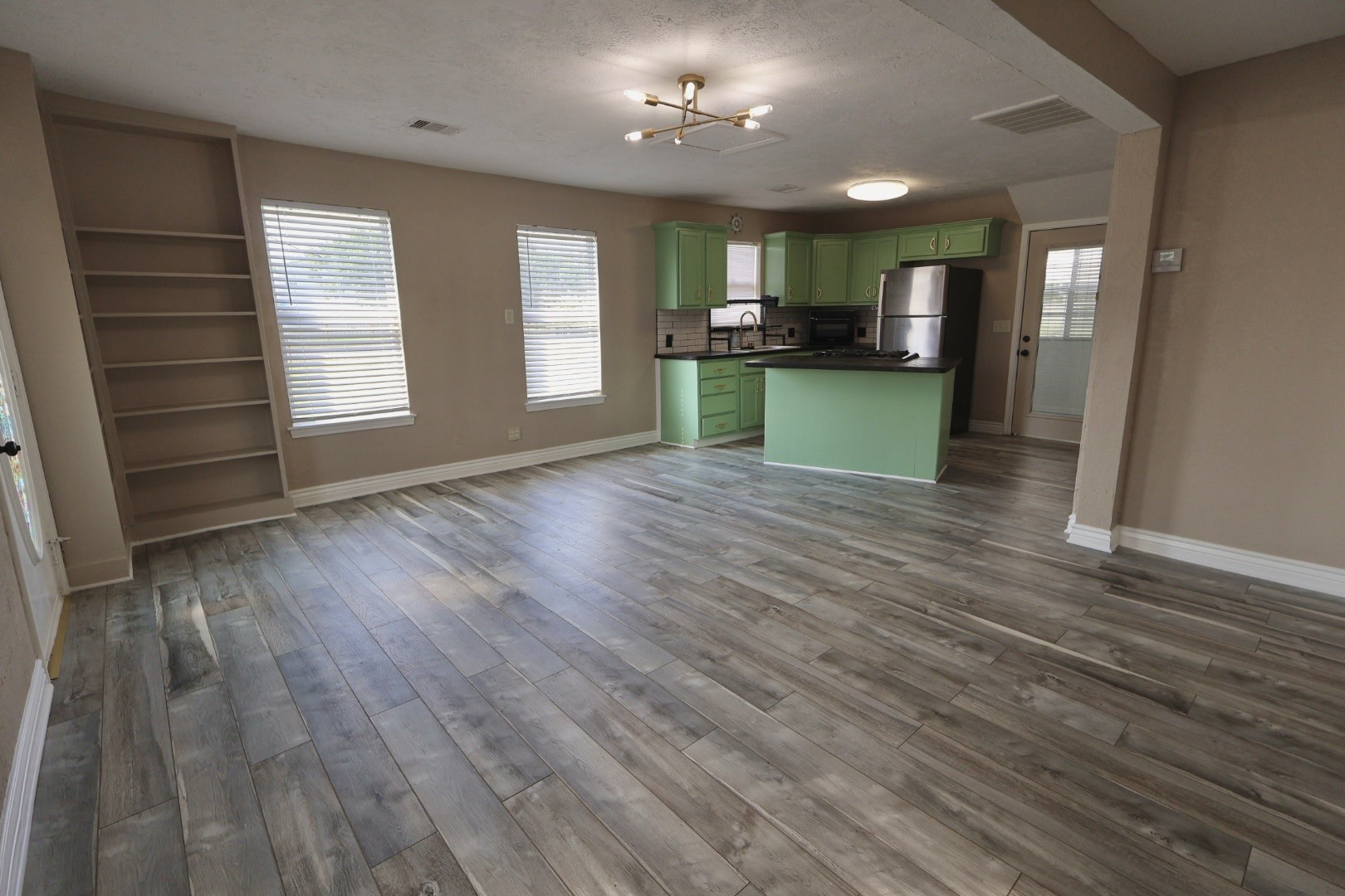 642 5th Street Dickinson, TX 77539 - Photo 5 of 20 Living room with a seamless view into the kitchen, creating an open and inviting layout