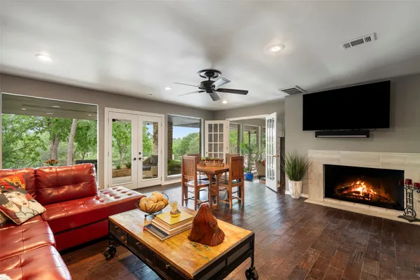 a living room with furniture a fireplace and a flat screen tv