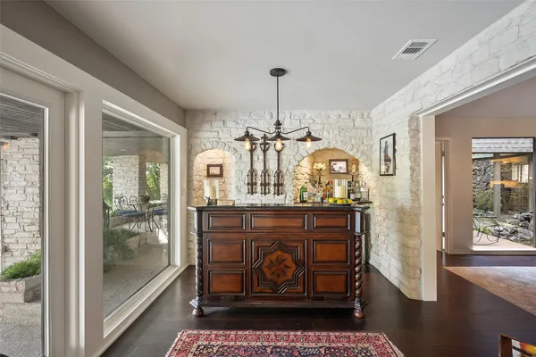 a bathroom with a granite countertop sink a mirror and shower