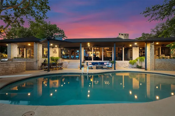 a view of a patio with dining table and chairs with wooden floor and fence