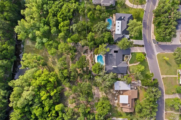 an aerial view of a house with a yard and lake view