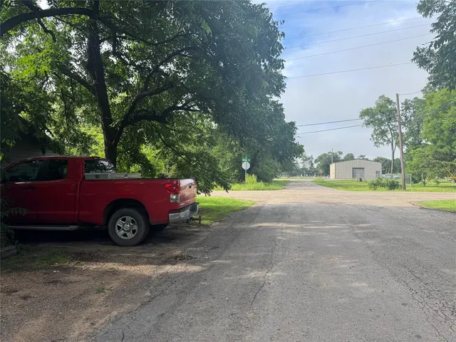 a view of backyard with a car parked