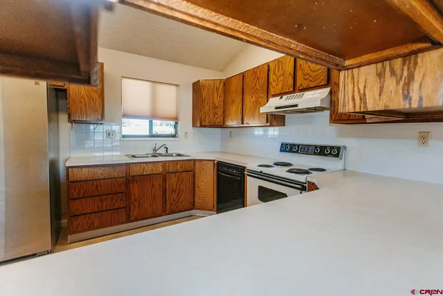 a kitchen with stainless steel appliances a refrigerator and a stove