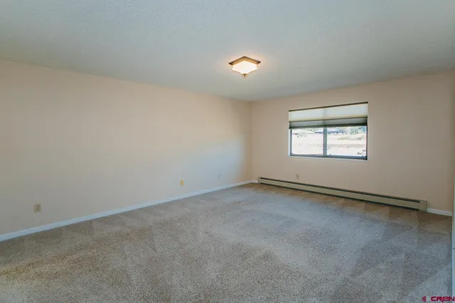 an empty room with a empty space and windows