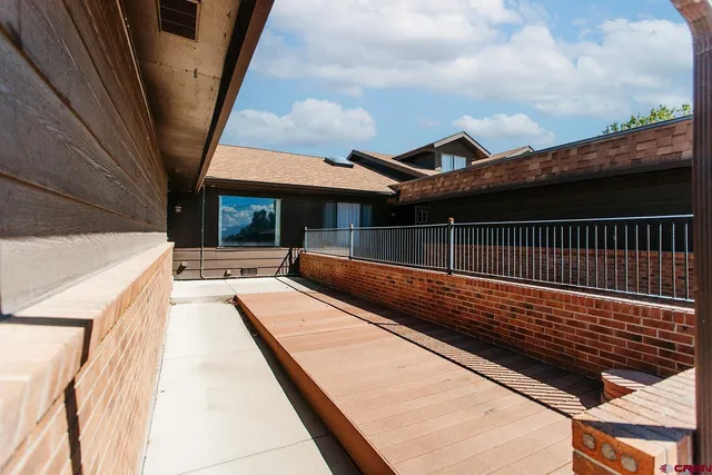 a view of balcony with wooden floor and outdoor seating