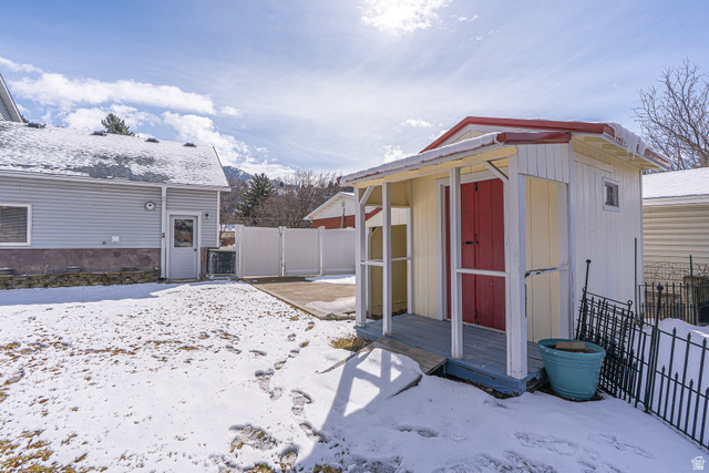 1045 Fox Farm Road Logan, UT 84321 - Photo 61 of 65 Snow covered structure with a storage shed and a gate