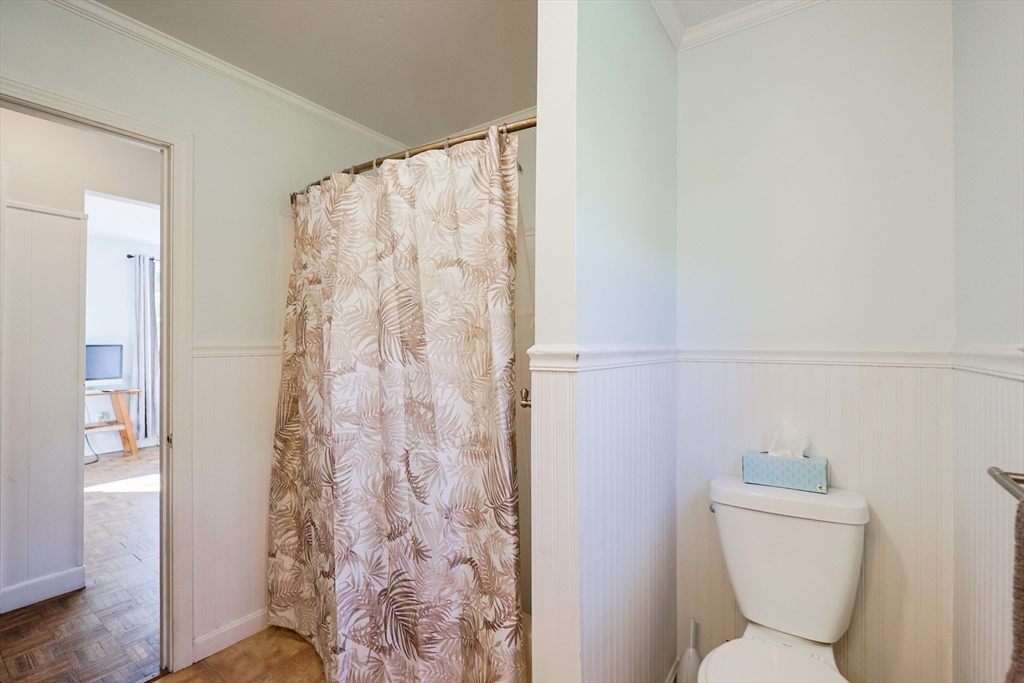 12 Randall Street Acushnet, MA 02743 - Photo 14 of 20 a white toilet sitting next to a shower curtain