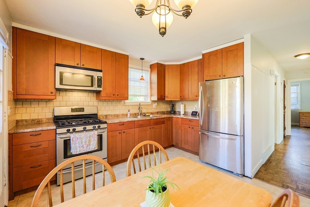 12 Randall Street Acushnet, MA 02743 - Photo 5 of 20 a kitchen with stainless steel appliances granite countertop a refrigerator a stove a sink and dishwasher
